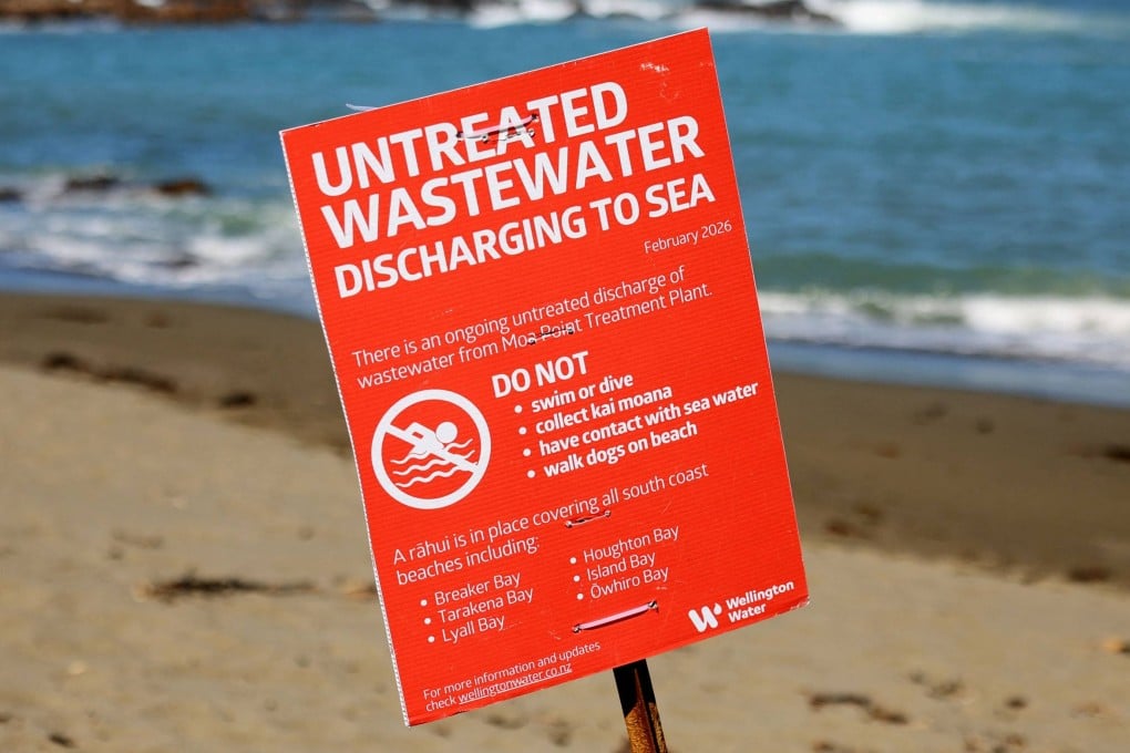 A warning sign is seen on Wellingtons South Coast on Monday after millions of litres of untreated sewage were discharged into the ocean. Photo: AFP