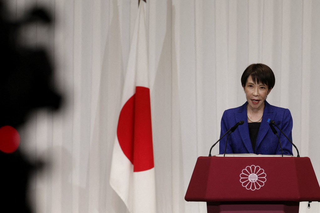 Japan’s Prime Minister Sanae Takaichi speaks next to a Japanese national flag during a press conference at the LDP headquarters in Tokyo on February 9. Photo: Reuters