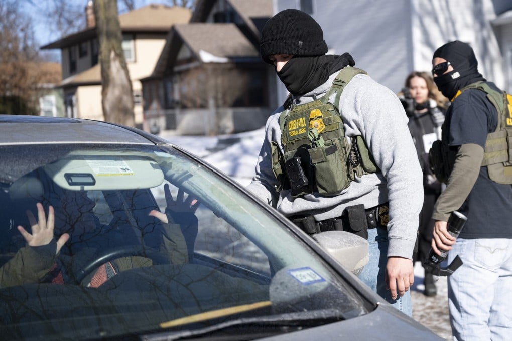 A member of the US Border Patrol confronts the driver of a car n Minneapolis on January 29. Photo: Getty Images/TNS