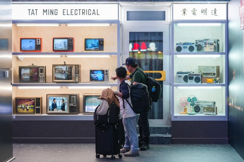 Travellers take a stroll down memory lane at the “City Reflections: Through Time and Change” exhibition at Hong Kong International Airport on December 27. Photo: Eugene Lee