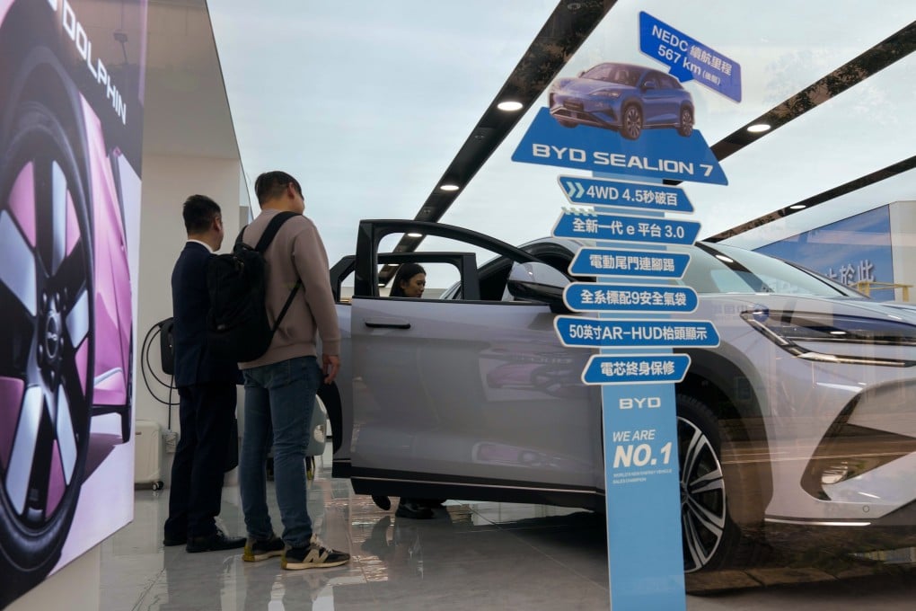 People shop for electric vehicles at a store in Wan Chai on February 26, after the financial secretary said subsidies for private EVs would not be renewed. Photo: Jelly Tse