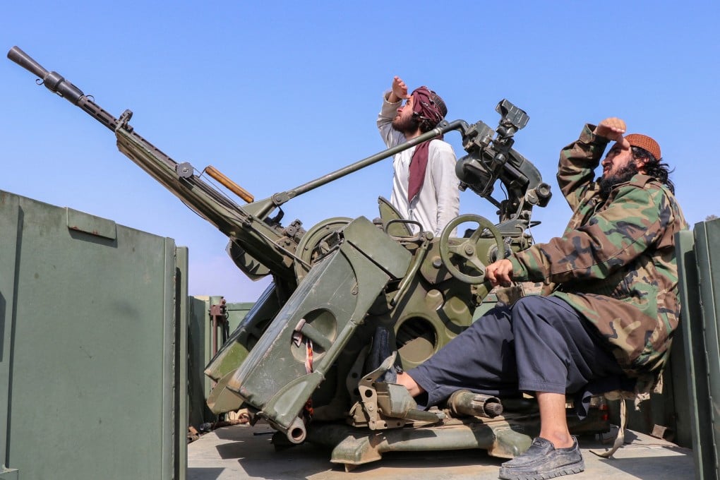 Taliban soldiers sit next to an anti-aircraft gun while on lookout for Pakistan’s fighter jets in Afghanistan’s Khost province on Friday. Photo: Reuters