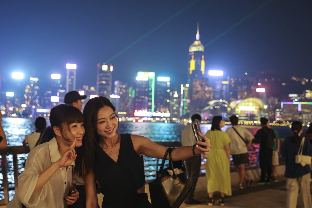 Tourists enjoy “A Symphony of Lights” at Tsim Sha Tsui’s Avenue of Stars. Photo: Yik Yeung-man