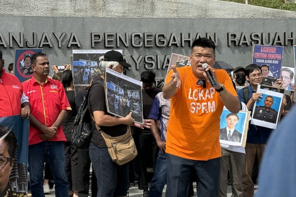 Rally organiser Albert Tei, clad in an orange MACC lock-up T-shirt, speaks in front of the anti-graft agency’s headquarters in Putrajaya on Friday. Photo: Iman Muttaqin
