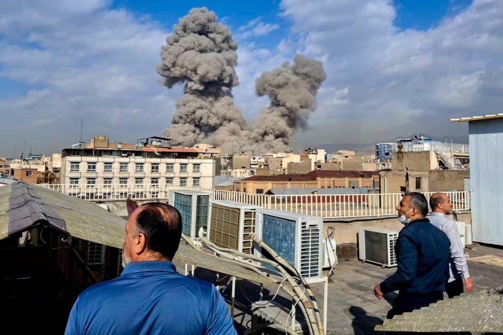 People watch as smoke rises on the skyline after an explosion in Tehran, Iran, on February 28. Photo: AP