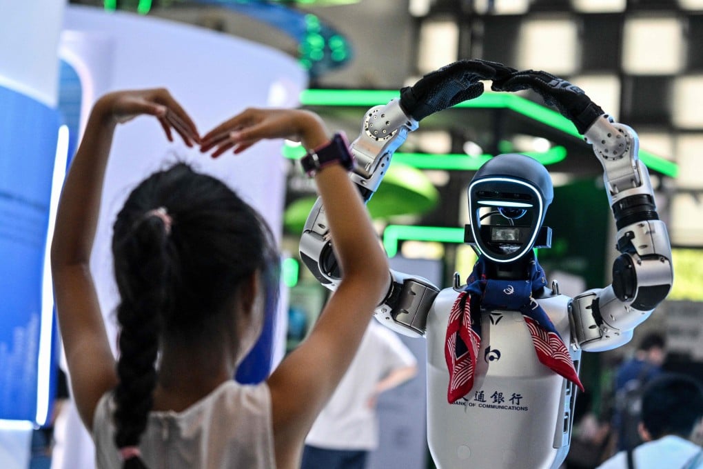 A girl plays with a robot during the World Artificial Intelligence Conference at the Shanghai World Expo and Convention Centre in Shanghai on July 28, 2025. Photo: AFP