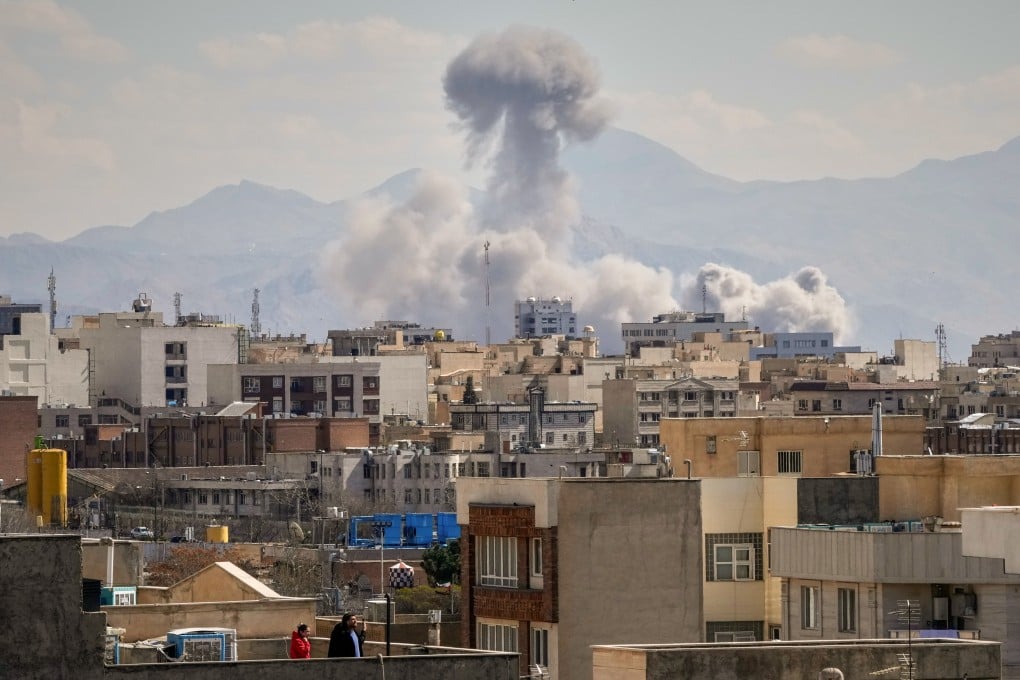 A plume of smoke rises after a strike in Tehran on Sunday. Photo: AP