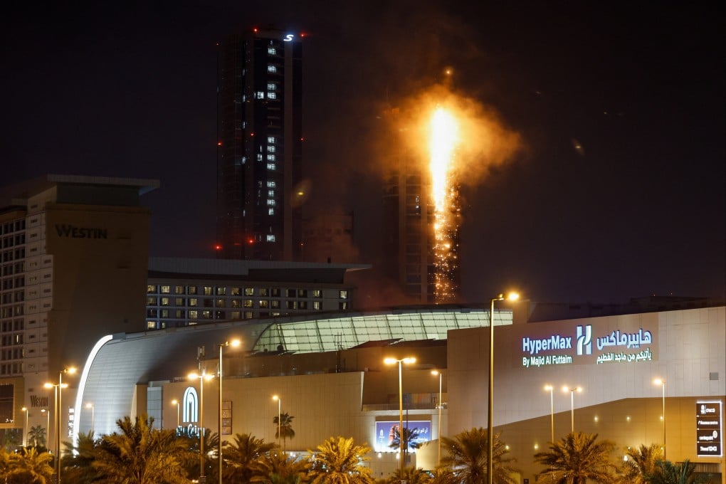 Smoke rises from a burning building hit by an Iranian drone strike in Seef district, Manama, Bahrain, on Saturday. Photo: Reuters