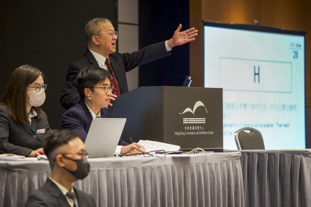 The auctioneer gestures as the “H” plate goes up for sale at the Hong Kong Convention and Exhibition Centre in Wan Chai. Photo: Handout