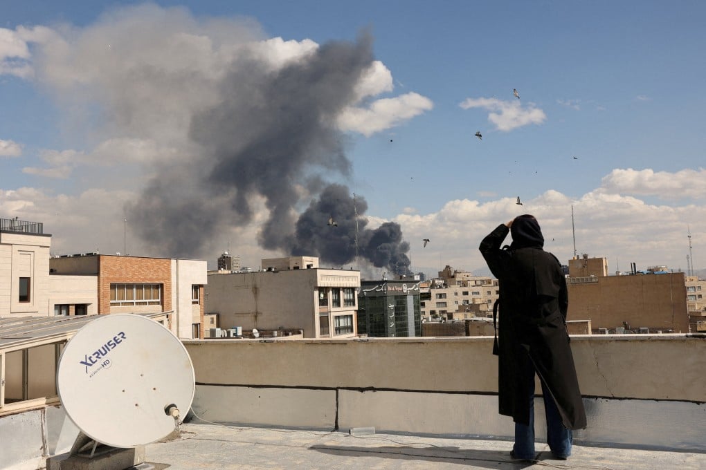 Smoke rises in in Tehran, Iran, on Sunday after Israel and the US launch strikes on the country. Photo: Reuters