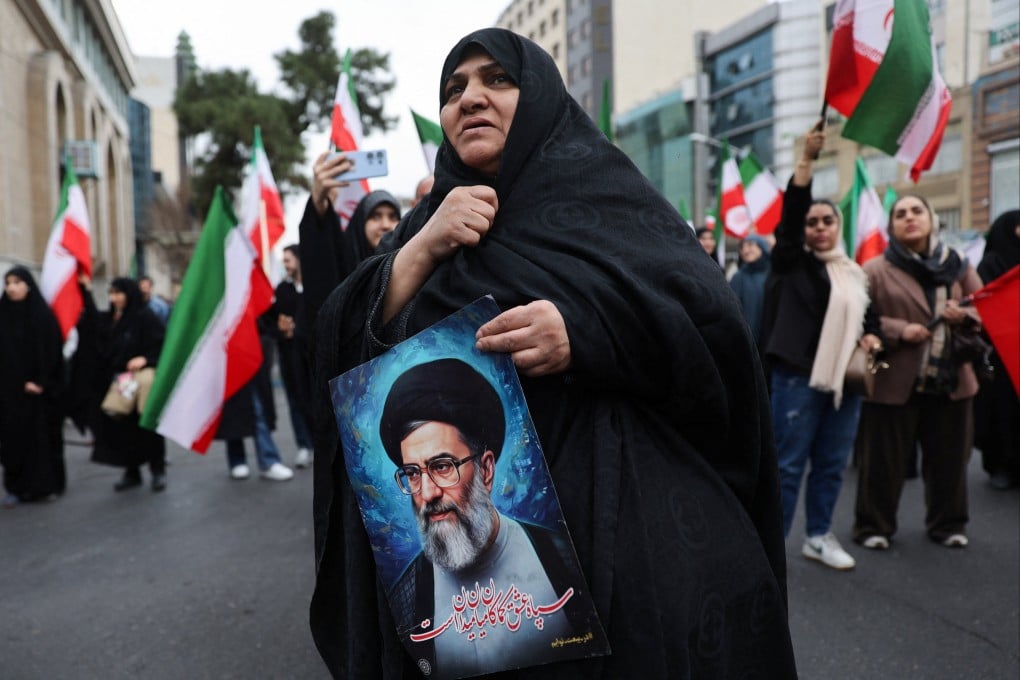 A woman holds an image of Iran’s Supreme Leader Ayatollah Ali Khamenei as Iranian demonstrators protest against the U.S.-Israeli strikes, in Tehran, Iran on February 28, 2026. Photo: Reuters
