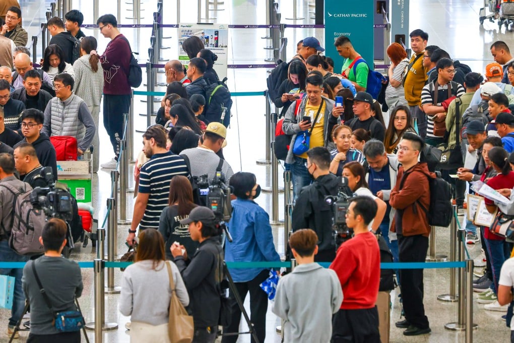 Passengers affected by disruptions to Cathay Pacific flights to Riyadh and Dubai queue to make inquiries at the airline’s check-in counters at Hong Kong International Airport on Saturday. Photo: Dickson Lee