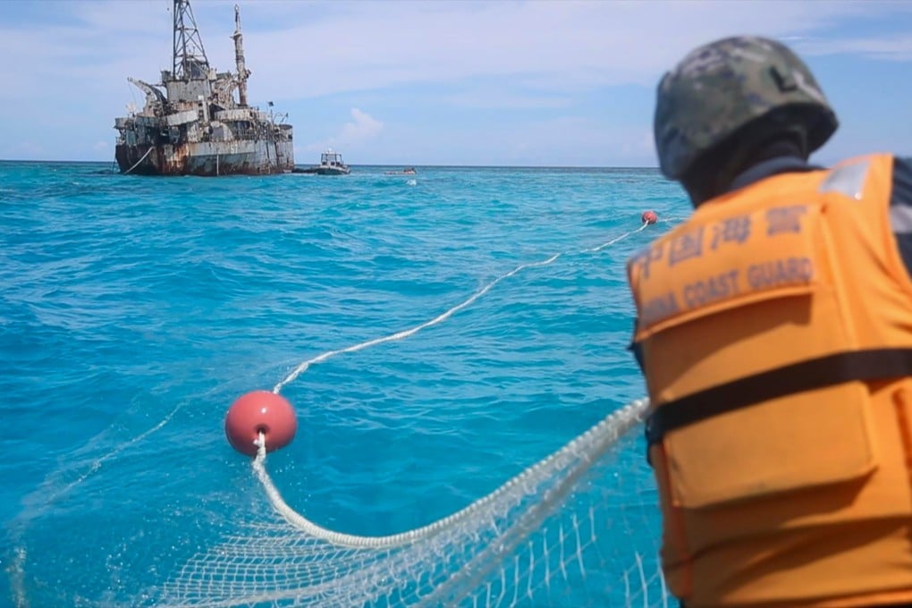 The Chinese coastguard recovers Philippine fishing nets near a disputed area of the South China Sea. Photo: Xinhua