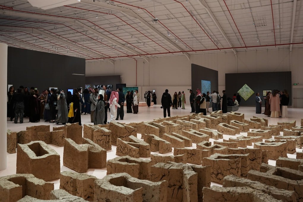 Visitors to the Diriyah Contemporary Art Biennale 2026 walk beside British-Filipino artist Pio Abad’s “Vanwa”, consisting of 99 letters made from locally sourced mud. Photo: courtesy of the Diriyah Biennale Foundation