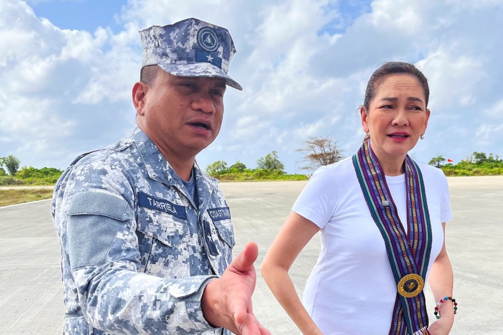 Philippine Coast Guard spokesman Jay Tarriela gestures beside Senator Risa Hontiveros during a visit to Philippine-occupied Thitu island in the disputed South China Sea on February 21. Photo: Reuters
