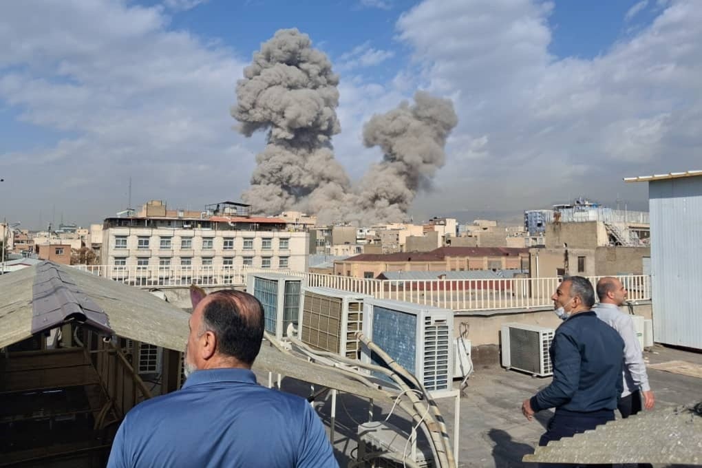 People watch as smoke rises on the skyline after an explosion in Tehran, Iran, on February 28. Photo: AP