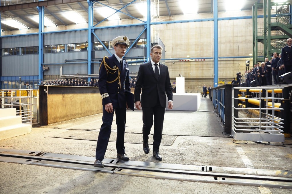 French President Emmanuel Macron, right, with an official at the nuclear submarines naval base of Ile Longue in Crozon, near Brest, France on Monday. Photo: EPA