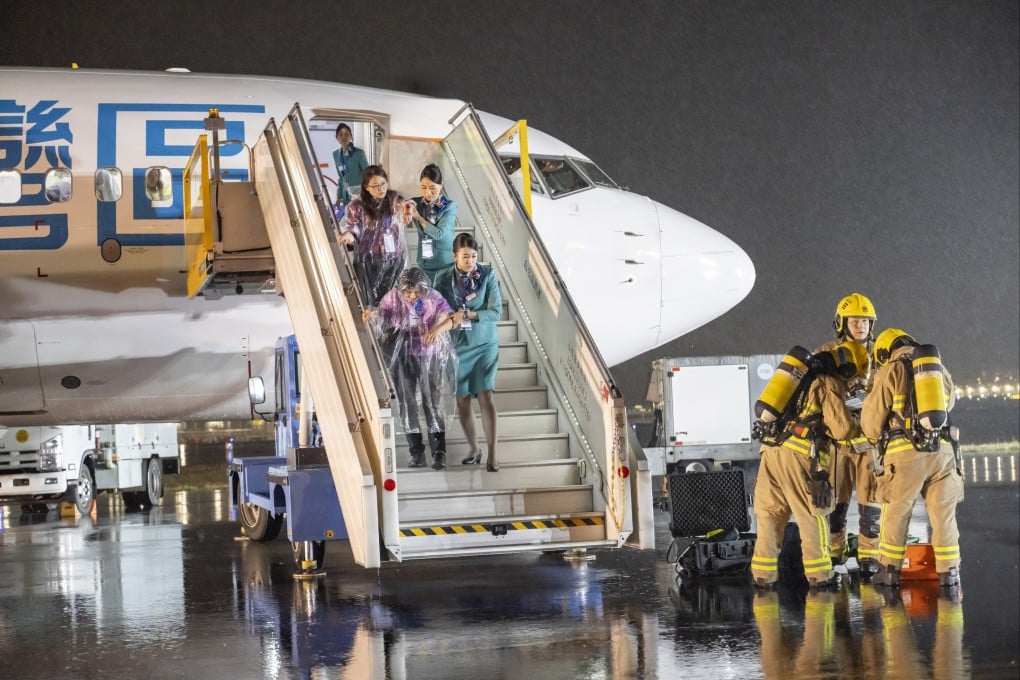In the drill, airline staff help passengers off the damaged plane, while emergency personnel stand by to provide further support. Photo: Handout