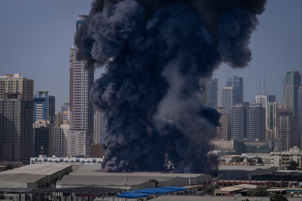 A black plume of smoke rises from a warehouse in Sharjah following reports of Iranian strikes in the UAE. Photo: AP
