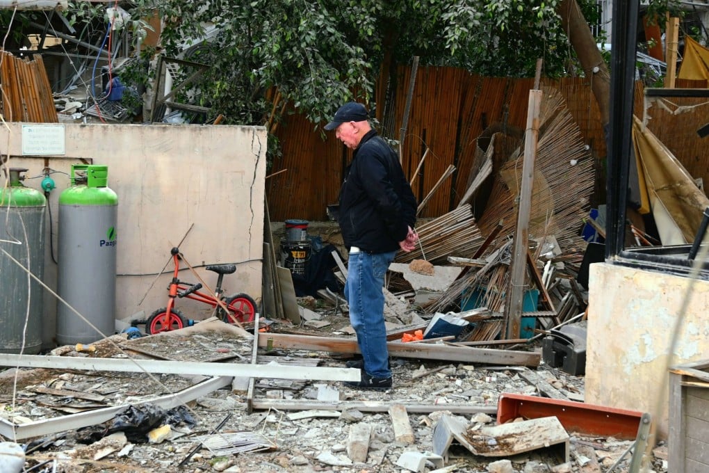 A resident inspects damage at his home in Tel Aviv on Sunday after a direct missile strike hit the area. Photo: dpa