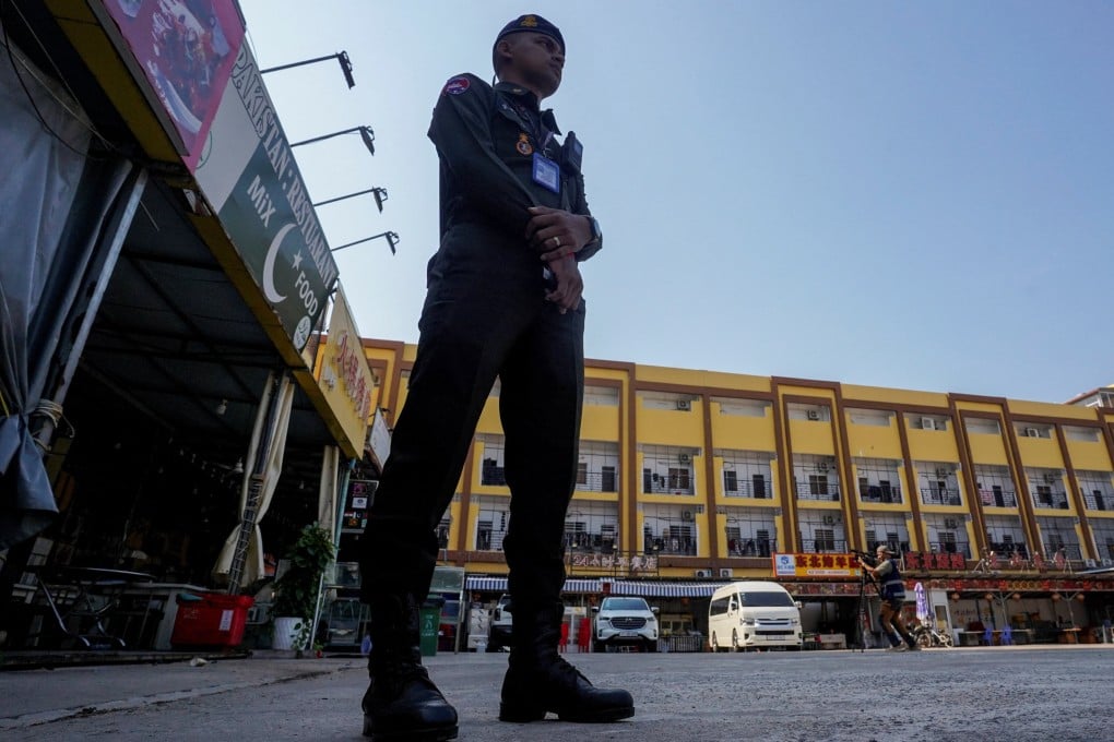 A Cambodian police officer stands guard near a scam compound in Kampot province, Cambodia, on February 10. Photo: Reuters