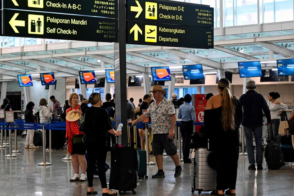 Passengers await news of their flights at Bali’s Ngurah Rai International Airport amid disruptions from  Israeli-US strikes on Iran on Monday. Photo: AFP