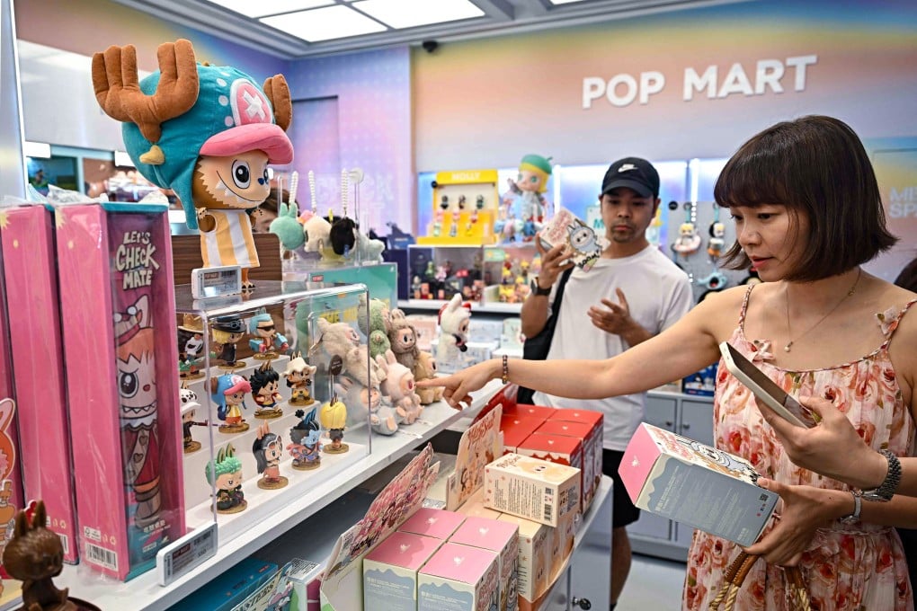 People pick up Labubu toys at a Pop Mart store in Siam Square in Bangkok on May 8, 2025. Photo: AFP