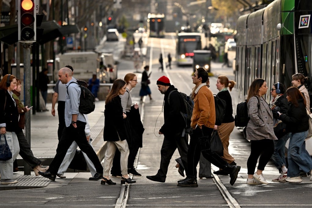 Pedestrians cross a street in Melbourne’s central business district. Photo: AFP