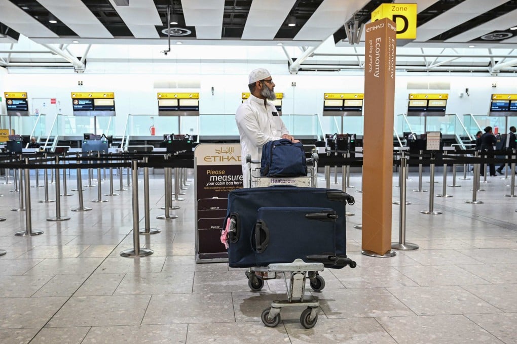 A man stands in front of a closed check-in counter for Gulf carrier Etihad at London Heathrow Airport on Sunday. Photo: AFP