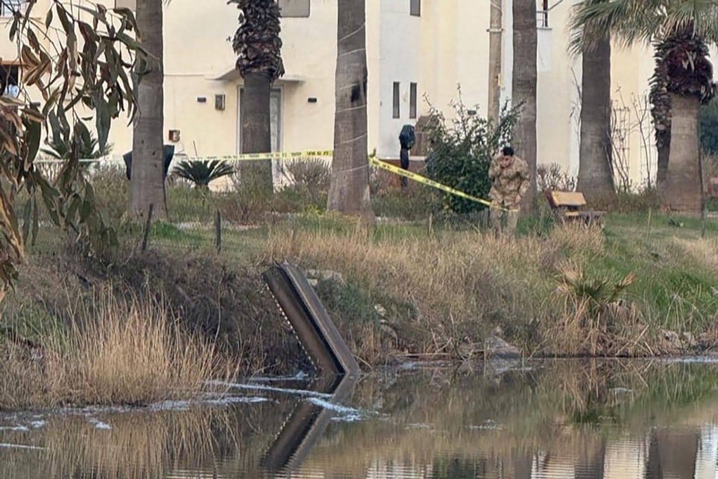 Turkish soldiers surround a munitions fragment identified as belonging to the air defence munitions that intercepted the threat after it was destroyed in the air, in the Dortyol district in Hatay. Photo: AFP/DHA