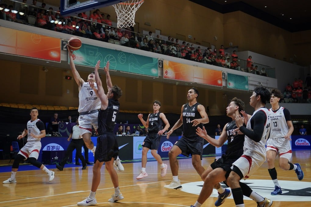 Hong Kong’s Tsang Cham-yuen tries to shoot against New Zealand’s Taylor Britt during their Fiba Asia Cup qualifier in February last year. Photo: Elson Li