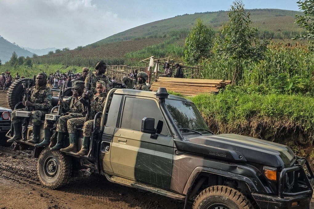 M-23 soldiers patrol near the open pit coltan mine in Rubaya, the Democratic Republic of Congo. Photo: AFP