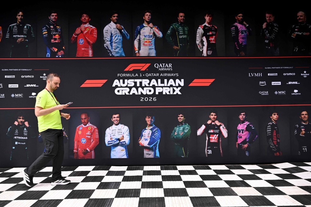 A crew member walks past images of drivers as teams prepare for Sunday’s Australian Grand Prix at the Albert Park Circuit in Melbourne. Photo: AFP