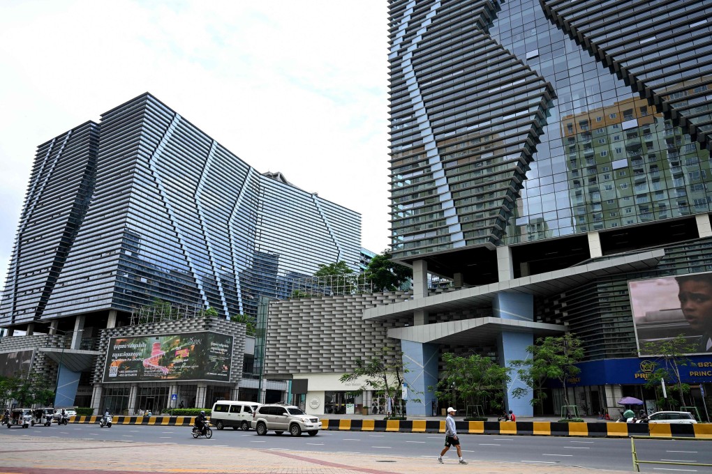 Vehicles drive past the Prince International Plaza in Phnom Penh on October 15, 2025. Photo: AFP