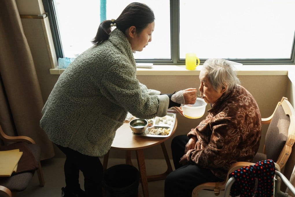 A daughter feeds her mother at a community elderly care centre in Suzhou, Jiangsu province in 2020. As families grow smaller in China, different generations face different decisions on elderly care. Photo: Xinhua