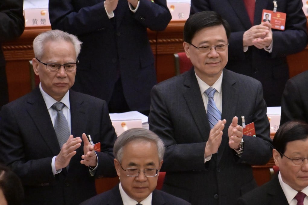 Hong Kong Chief Executive John Lee Ka-chiu (right), beside Macau Chief Executive Sam Hou-fai, at the opening meeting of the fourth annual session of the 14th National People’s Congress in Beijing on March 5. Photo: Handout