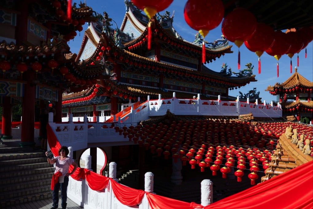 A tourist takes a selfie at the decorated Thean Hou Temple in Kuala Lumpur, Malaysia, last month. Photo: Reuters