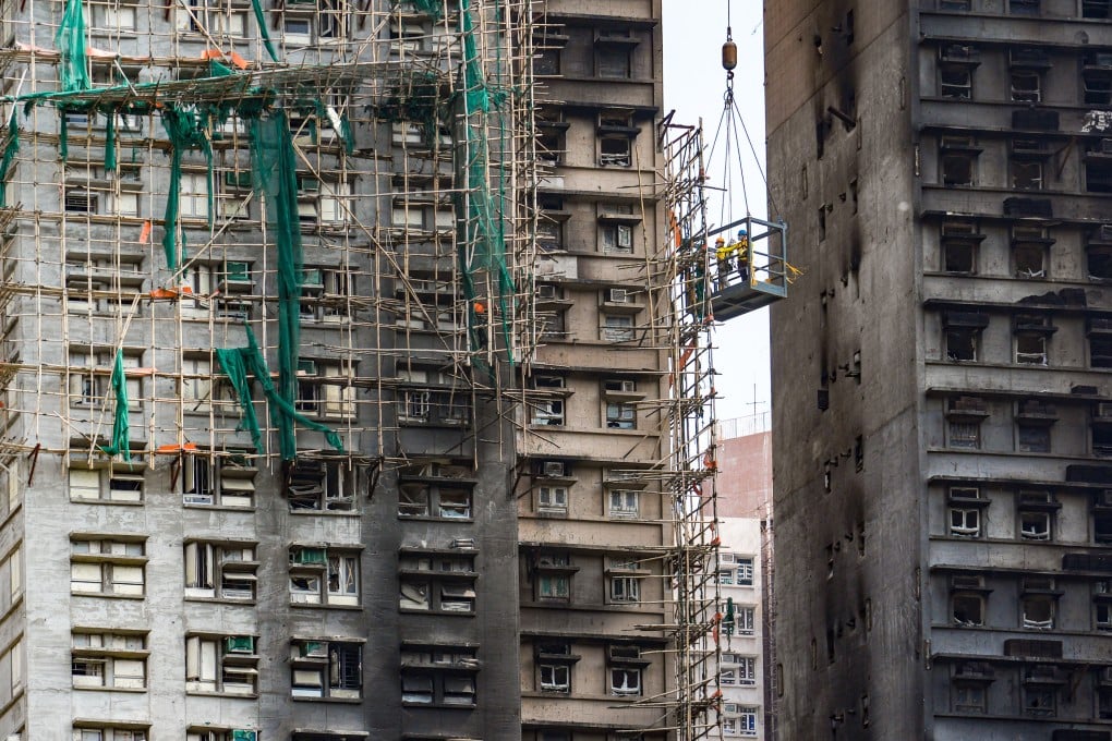 Workers dismantle bamboo scaffolding at Wang Fuk Court in Tai Po last month. Photo: Eugene Lee