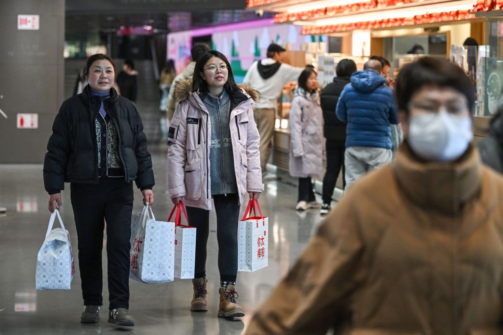 Shoppers at a shopping centre in Beijing last month. Photo: Xinhua