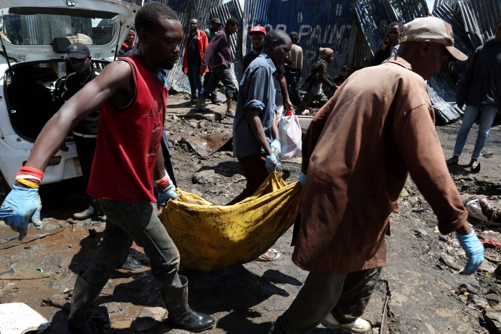 Volunteers carry the body of a person killed by flooding on Saturday following heavy rainfall in Nairobi, Kenya. Photo: Reuters