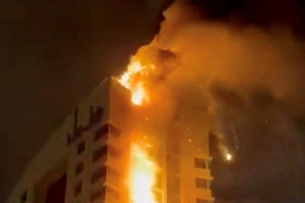 Smoke rises from a building on fire, in the aftermath of what the Kuwaiti Army says is a drone attack, amid the US-Israeli conflict with Iran, in Kuwait City on Sunday in this screengrab from a social media video. Photo: social media via Reuters