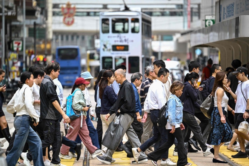 Pedestrians cross a busy intersection in Hong Kong’s Central district on February 25. Photo: AFP