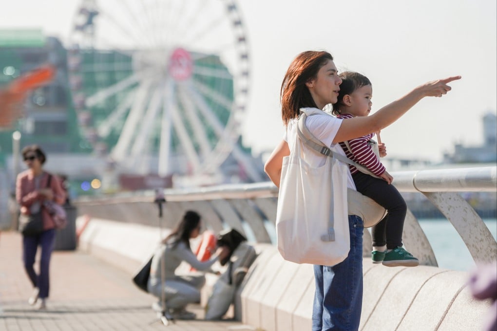 A woman and a child at Central Harbourfront. Women account for 54 per cent of Hong Kong’s population, city leader John Lee says. Photo: Eugene Lee