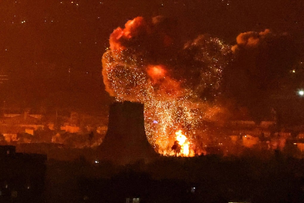 An explosion erupts following strikes near Azadi Tower close to Mehrabad International Airport in Tehran on Saturday. Photo: AFP