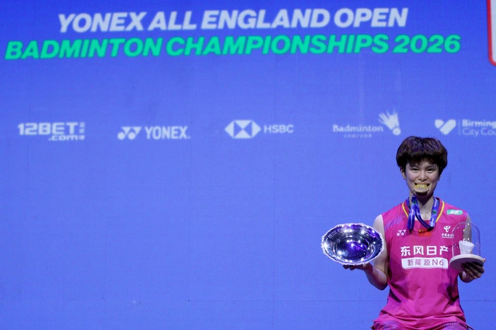 Wang Zhiyi poses with her medal and trophy after winning the women’s singles at the All England Open Badminton Championships. Photo: Xinhua