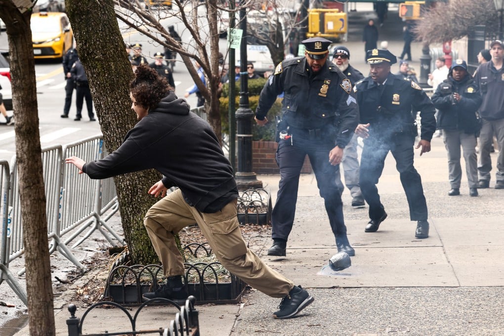 A man flees after throwing a home-made explosive device towards police in New York on Saturday. Photo: AFP