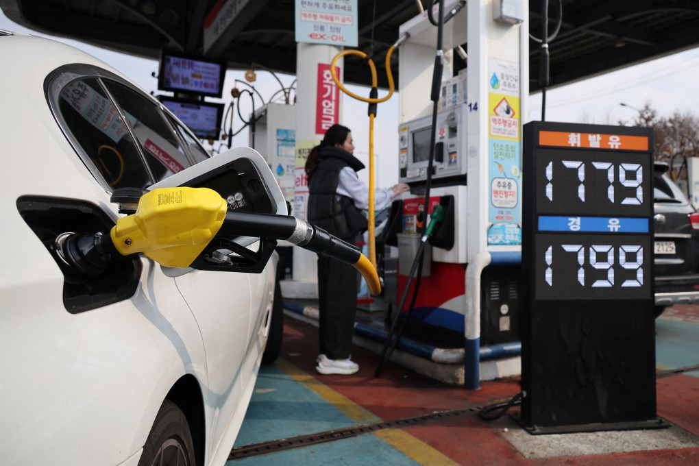 A woman fills up her car at a petrol station in Seoul, South Korea, on Monday. Photo: Reuters