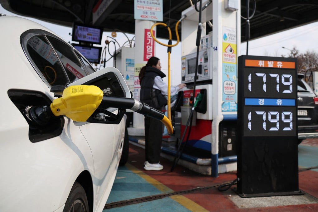 A woman fills up her car at a petrol station in Seoul, South Korea, on Monday. Photo: Reuters