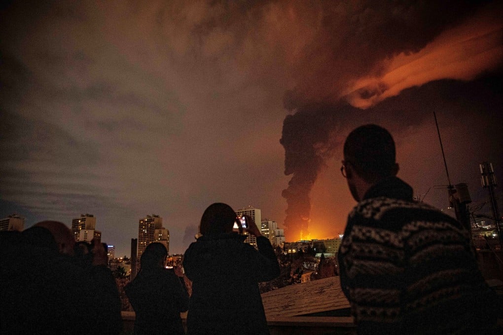 Flames and smoke rise from an oil storage facility struck in Tehran on Saturday. Photo: ISNA via AP