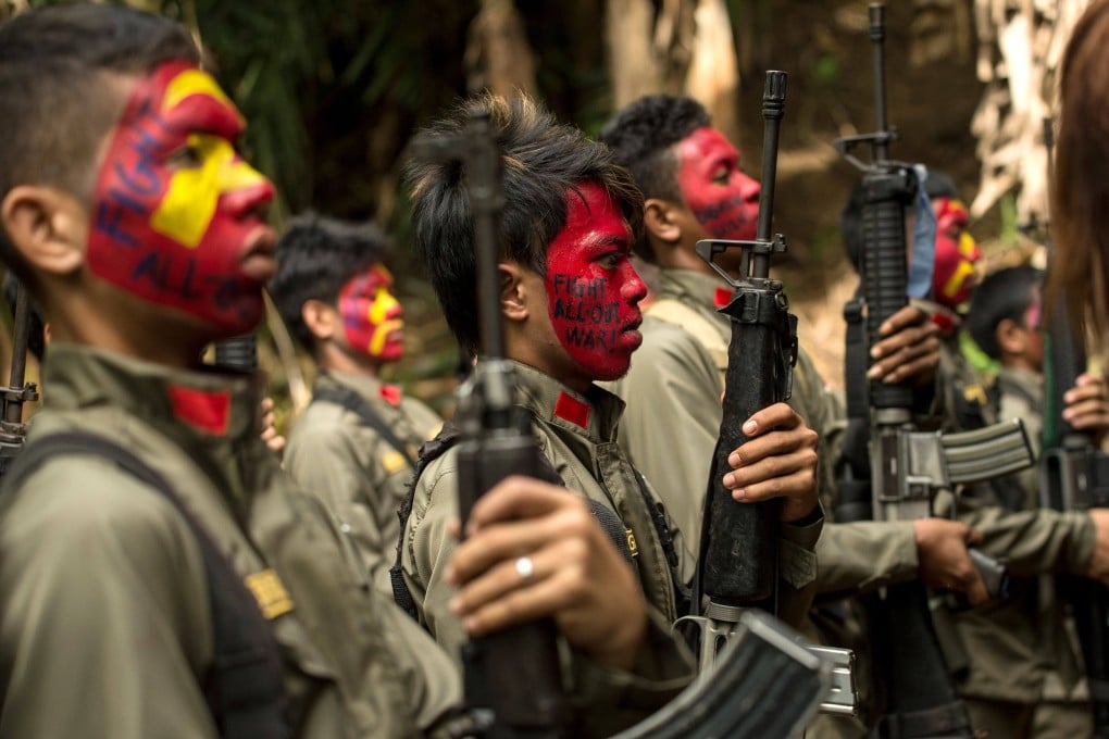 New People’s Army (NPA) guerrillas stand in formation at a base in the Sierra Madre mountain range, east of Manila, in 2017. Photo: AFP